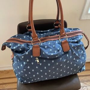 Blue weekender bag with sailboat motif and faux leather straps